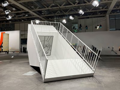 The entrance of an underground subway station with a mirrored door that is closed.