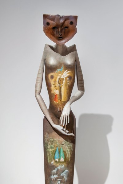 A sculpture of a man with a cat-like head.