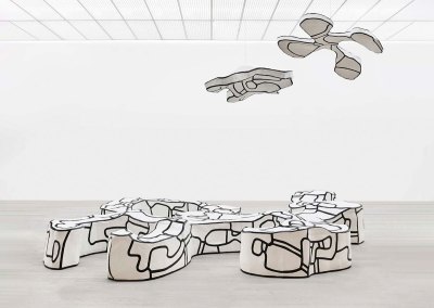 A Jean Dubuffet sculpture of a bench with two hanging elements.