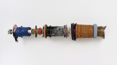 A wall-hung sculpture comprised of various found materials.