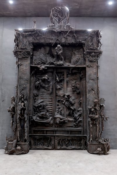 A sculpture resembling Rodin's 'Gates of Hell' but looks more derelict.