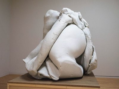 A sculpture that resembles a body and mounds of clay.