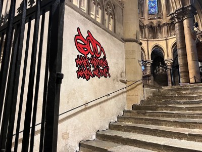 A decal in graffiti-like font reading 'GOD, WHAT HAPPENS WHEN WE DIE?'