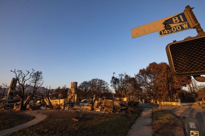 LOS ANGELES CALIFORNIA - JANUARY 18: A burned street sign for Sunset Boulevard stands near homes that burned in the Palisades Fire on January 18, 2025 in the Pacific Palisades neighborhood of Los Angeles, California. Twenty-seven people are confirmed killed by wildfires in Los Angeles County so far as urban search and rescue teams continue combing through the destruction. Historic wildfires driven by dry conditions and powerful Santa Ana winds destroyed homes by the thousands, beginning January 7. The region has had virtually no significant rain since last winter, lowering the moisture content in the local chaparral habitat vegetation and increasing its flammability. Scientists say that fluctuating years of extreme weather conditions - record drought years broken by record or near-record rainy winters - is fueled by worsening human-caused climate change. No rain is in the forecast at this time and communities are bracing for a possible return of dangerous fire weather next week.  (Photo by David McNew/Getty Images)
