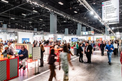 An art fair with people lounging on chairs.