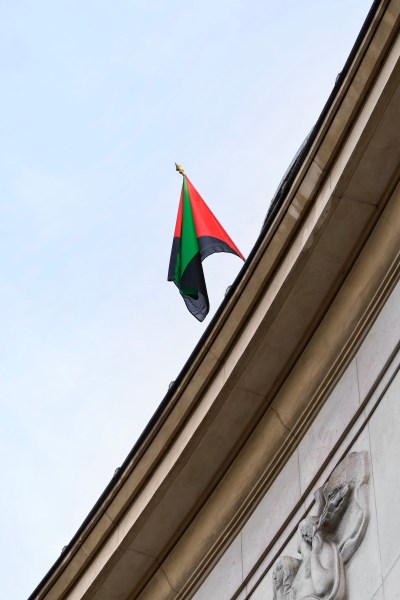 A Martinican flag hanging above a roof.