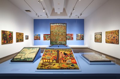 A gallery with many textiles in it.