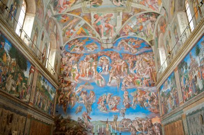 A painted wall of a chapel with many figures flying through the sky.