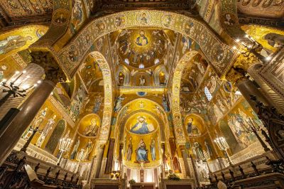 A golden chapel with paintings across its ceiling.