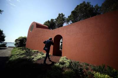A man walking into a brown building.