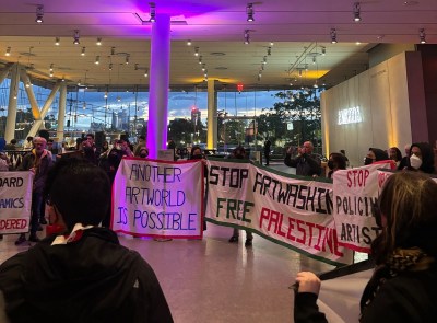 A group of protesters in a museum lobby.