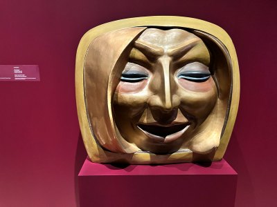 A fiberglass sculpture of a large head of a blonde woman. 