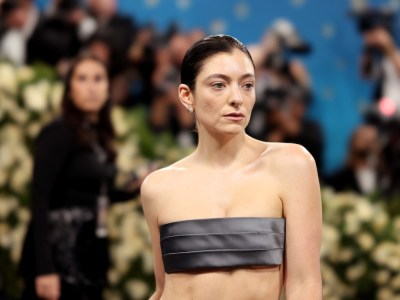 A woman wearing gray fabric over her breasts.