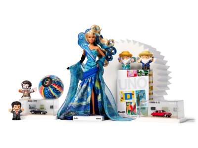 A doll surrounded by figurines and card packs.