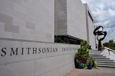 A building facade with the words 'Smithsonian Institution' etched into it.