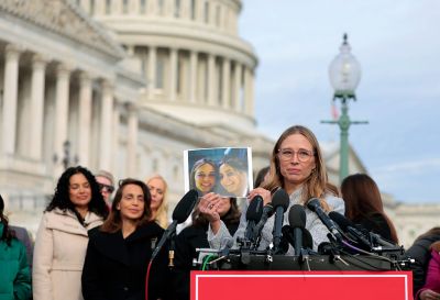 WASHINGTON, DC - NOVEMBER 18: Epstein abuse survivor Annie Farmer holds up a photo of her younger self with her sister Maria Farmer during a news conference with lawmakers on the Epstein Files Transparency Act outside the U.S. Capitol on November 18, 2025 in Washington, DC. The House is expected to vote today on the legislation, which instructs the U.S. Department of Justice to release all files related to the late accused sex trafficker Jeffrey Epstein. (Photo by Heather Diehl/Getty Images)