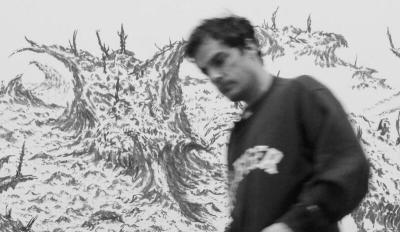 A blurred man moving past a drawing of a landscape.