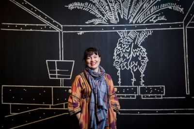 Yto Barrada standing in her exhibition "Agadir" at the Curve Barbican Centre, London, 2018.