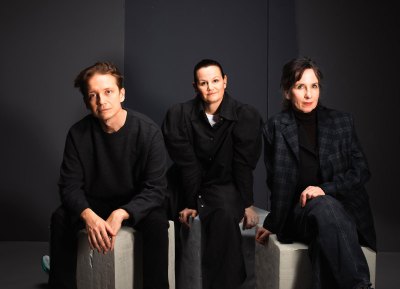A group portrait of artists Benjamin Orlow, Tori Wrånes, Klara Kristalova against three black backdrops.
