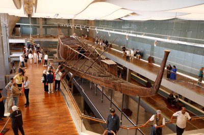 Tourists visit King Khufu's solar boat at the Grand Egyptian Museum in Giza, Egypt, on Nov. 4, 2025.