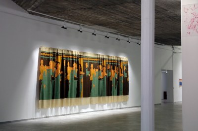 A painting of many people on a curtain.