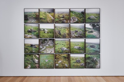 A grid of photographs of a grassy field with rocks and gates in it.