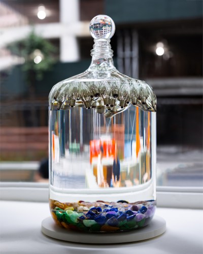 A glass with suspended lights in a clear solution.