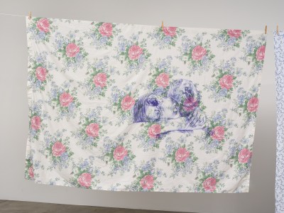 An image of two women embracing each other printed onto a floral print fabric.