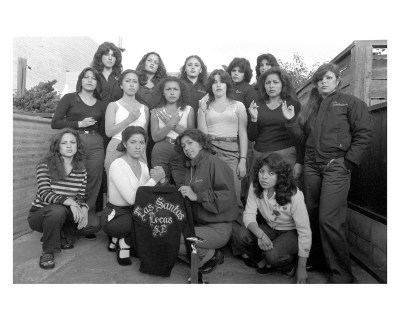 A group of women posed together. One holds shirt reading 'LAS SANTAS LOCAS.'